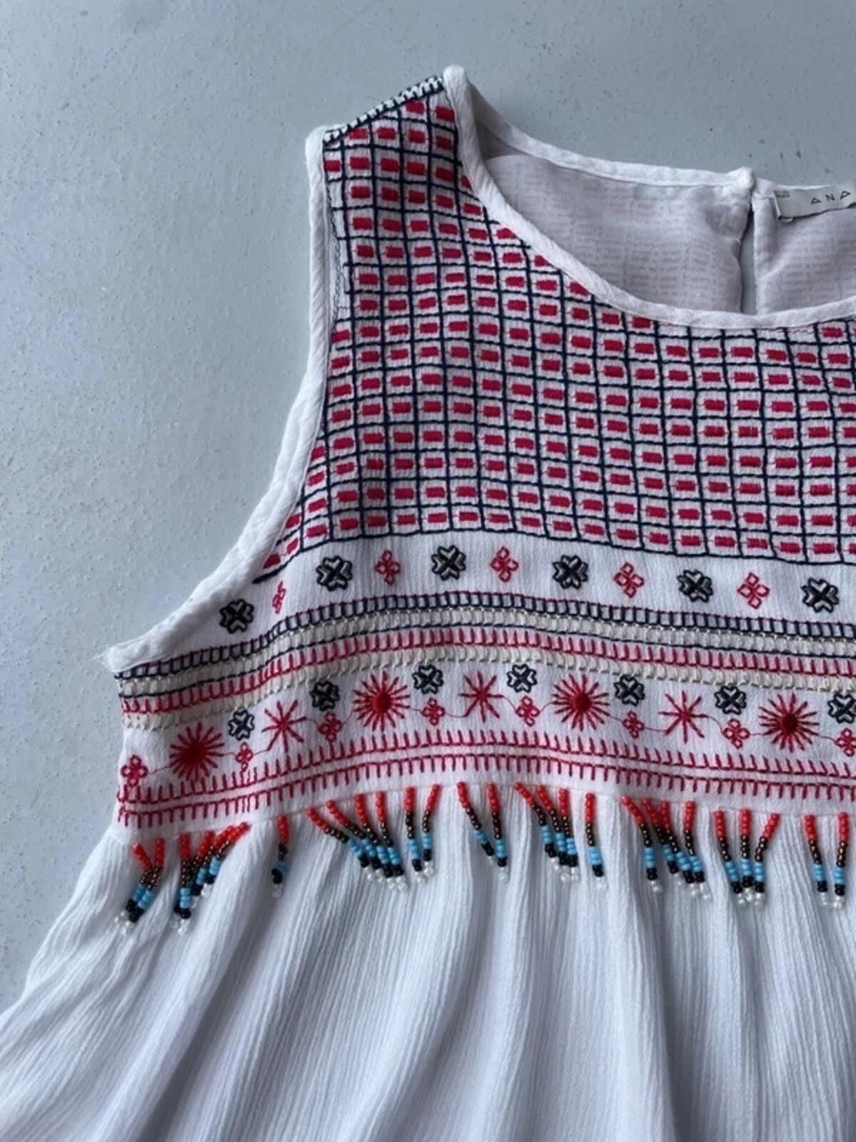 White cami with red embroidery and beading