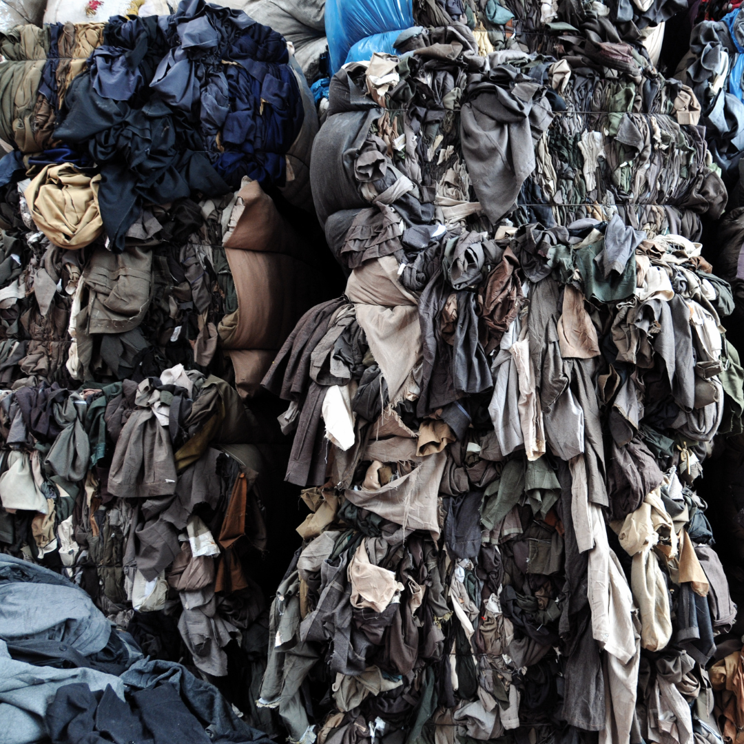 stack of unsorted clothes in colour coordinations