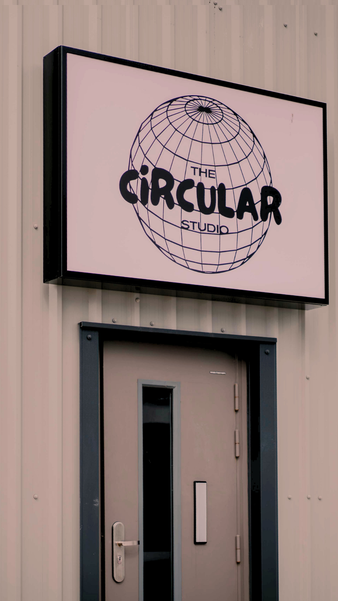 Sign for 'The Circular Studio' on a building facade